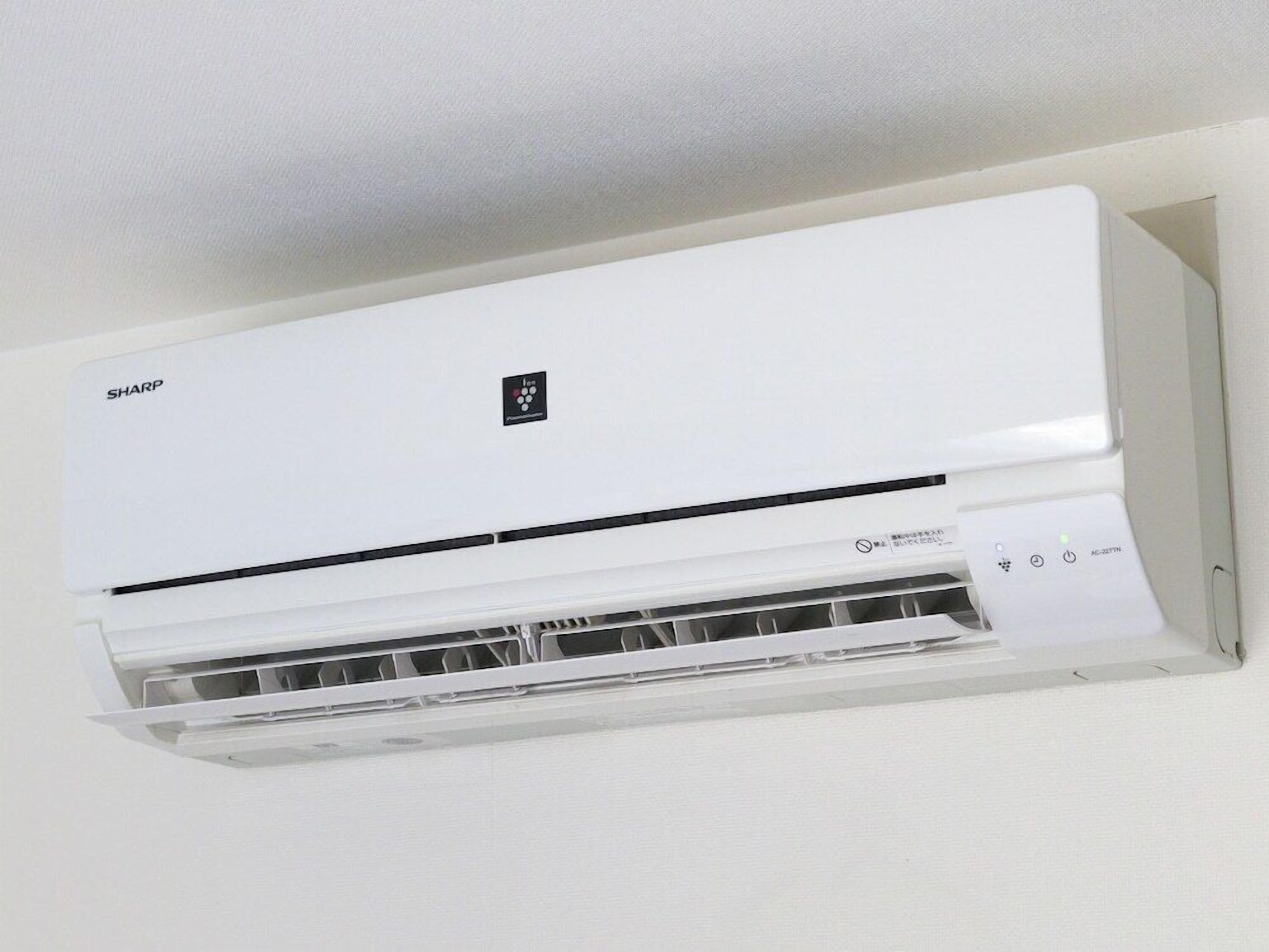A white air conditioning unit mounted on a wall.