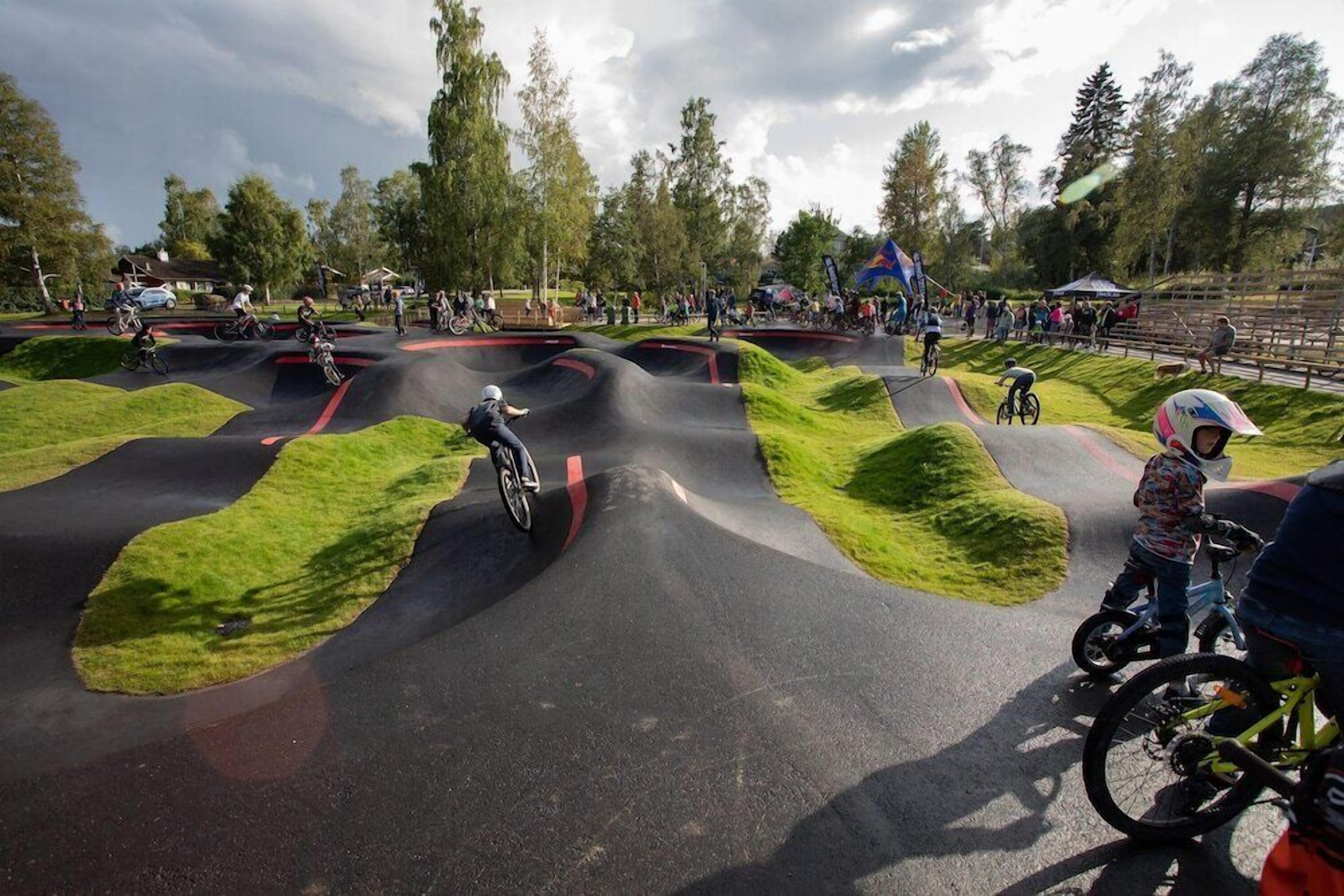 A BMX track with riders navigating the curves.