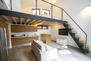 A modern loft apartment with a kitchen, dining area, and living space. - DESIGN CENTRAL APARTMENT (Bergamo)