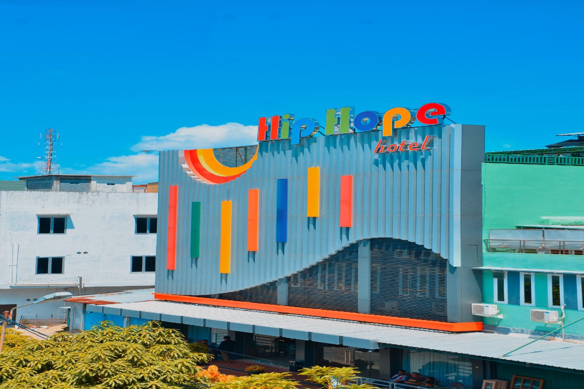 A hotel with a colorful facade and a prominent sign.