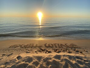 A beach with footprints and the words "Beach Lovers" written in the sand. - NEW & Modern South Haven Beach House (South Haven)