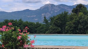 A swimming pool with a mountain backdrop.
