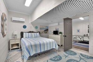 A bedroom with a bed, a dresser, a desk, and a door leading to another room. - Tabby on the Tee - Four Bedroom House, Sleeps 15 (Fripp Island)