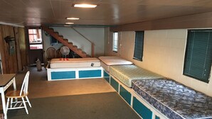 A compact room with a bunk bed, a desk, and a chair. - Priest Lake BEACHFRONT w 2 slip Dock (Priest Lake Idaho)