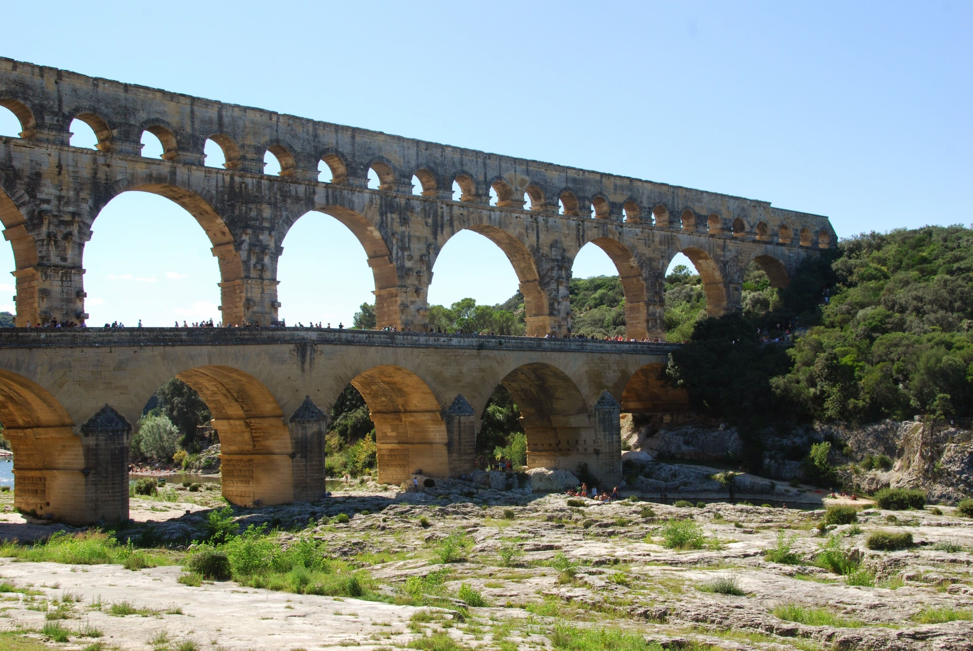 A large stone bridge with multiple arches spanning a river.