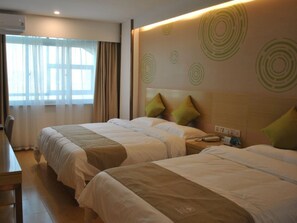 A hotel room with two beds, a desk, and a window with curtains. - Greentree Heze Changcheng Road Tianhua Ecommerce Logistics Park Express Hotel (Heze)