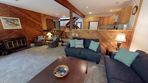 A cozy living room with a sofa set, a coffee table, and a fireplace. - Harbor Cove! 5 Bedroom! #82 Ski, Golf, Shop! (Harbor Springs)