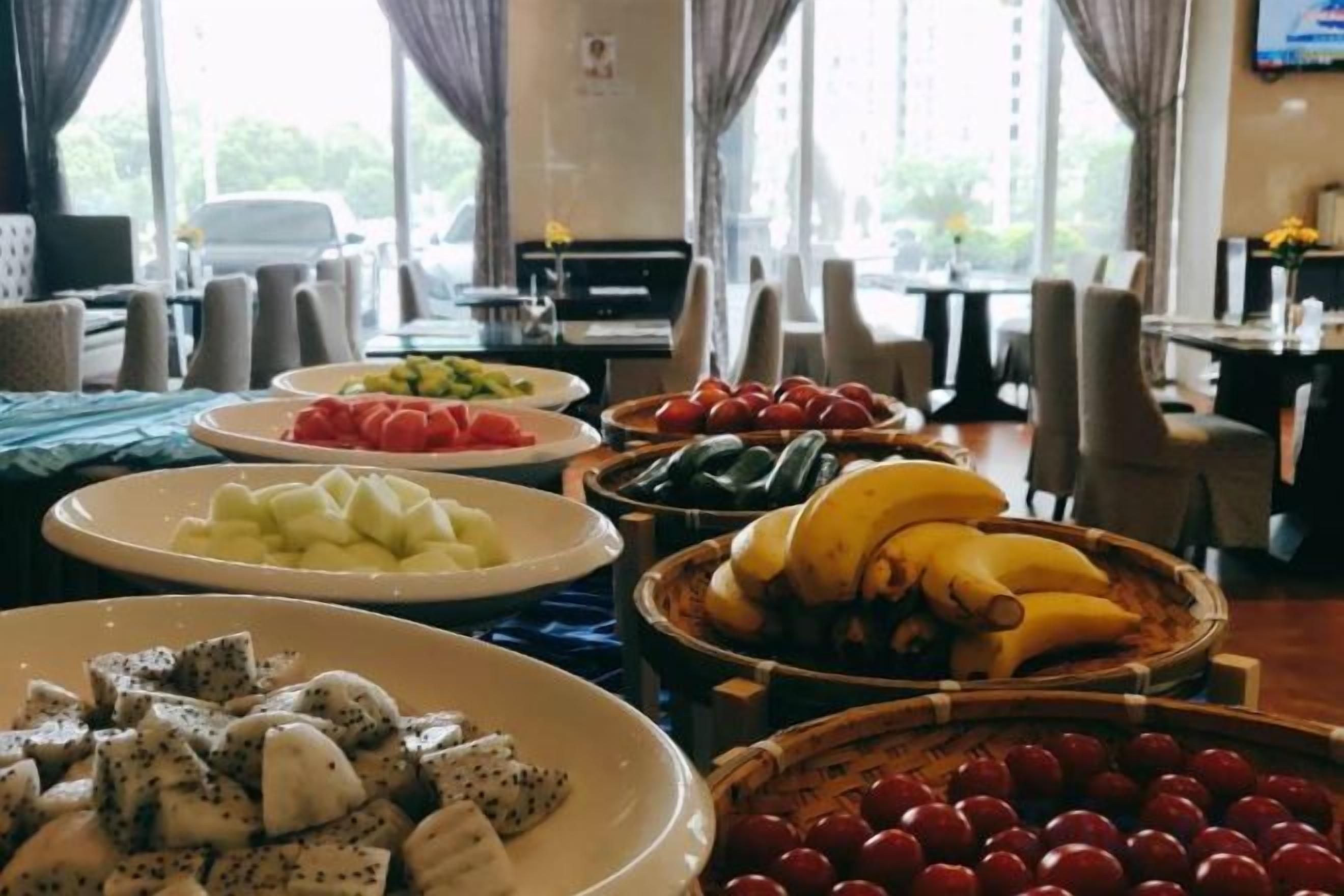 A buffet with various fruits and vegetables.