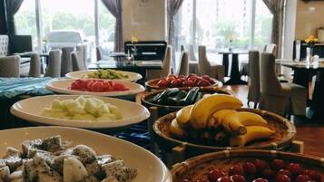 A buffet with various fruits and vegetables.