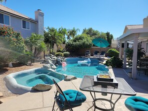 A backyard with a swimming pool, lounge chairs, and a barbecue area. - Renovated WATERSLIDE private Heated pool with Spa Golf Course on-call service  (Mesa)
