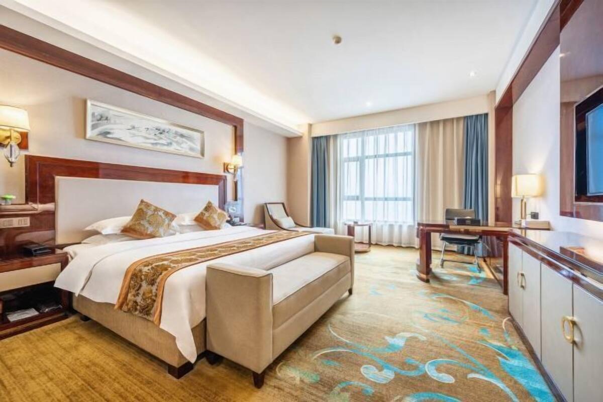 Relax in comfort with a large bed, a convenient nightstand, and a desk for work or leisure.