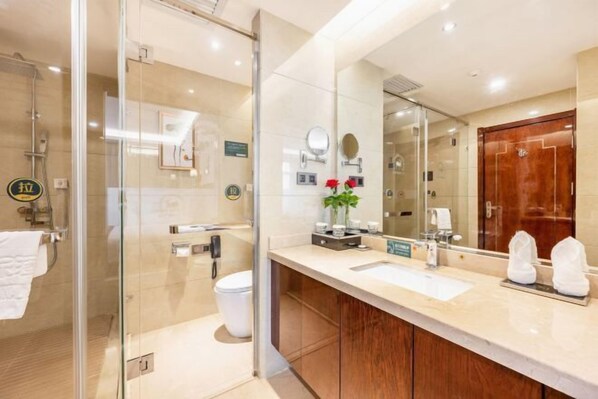 A modern bathroom with a glass shower enclosure, a sink with a vanity, and a large mirror. - Xixia International Hotel (Cheng County)