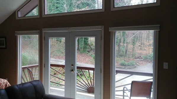 A room with a large sliding glass door leading to an outdoor deck.