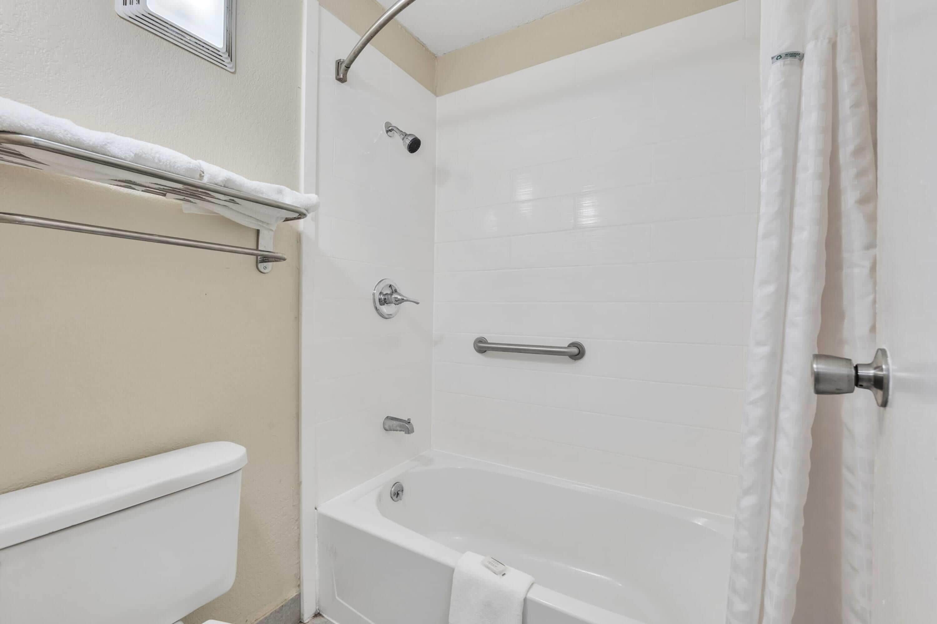 A bathroom with a bathtub, a shower, and a toilet.