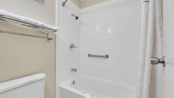 A bathroom with a bathtub, a shower, and a toilet.