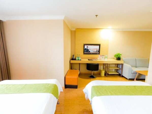 A hotel room with two beds, a desk with a computer, a chair, and a sofa. - Greenhouse Hotel, Tongji Hospital, Guangxin Road, Shanghai (Shanghai)