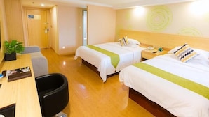 A hotel room with two beds, a desk, a chair, and a small table with a plant. - Greenhouse Hotel, Tongji Hospital, Guangxin Road, Shanghai (Shanghai)