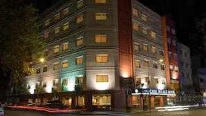 A multi-story hotel with a prominent entrance and a sign reading "Cadi Palace Hotel".