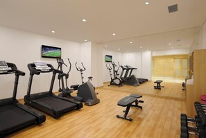A gym with treadmills, elliptical machines, and weight benches. - Holiday Inn Express Pune Pimpri (Pune)