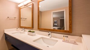 A modern bathroom with two sinks, a large mirror, and a small plant on the counter. - Aiden By Best Western Cape Cod - West Yarmouth (West Yarmouth)