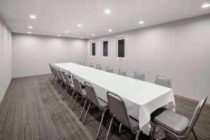 A conference room with a long table, chairs, and a carpeted floor. - Aiden By Best Western Cape Cod - West Yarmouth (West Yarmouth)