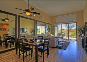 Relax in this spacious living area with a large dining table and comfortable seating.