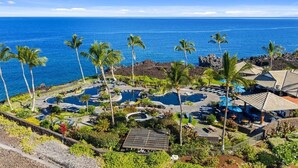 A resort with multiple swimming pools, palm trees, and a view of the ocean. - Secluded 2-Suite - Stocked Like you're at home. Ocean front pool, private lanai (Waikoloa Village)
