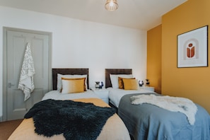 A double room with two beds, a door, a framed picture, and a ceiling light. - Brand New Townhouse In Rugby (Rugby)