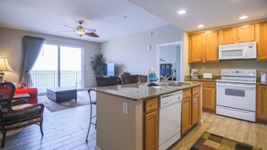 A modern kitchen with wooden cabinets, a built-in microwave, and a dishwasher.