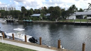 A marina with boats docked, a wooden walkway, and a calm water body. - STUNNING WATERFRONT 2 BEDROOM BEAUTY.  CLOSE TO EVERYTHING. (Fort Lauderdale)