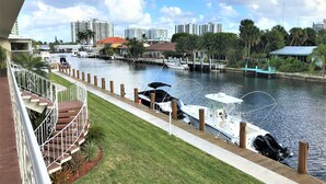 A marina with boats docked, a waterfront view, and buildings in the background. - STUNNING WATERFRONT 2 BEDROOM BEAUTY.  CLOSE TO EVERYTHING. (Fort Lauderdale)