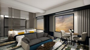 Une chambre d’hôtel moderne équipée d’un lit, d’un canapé et d’une table ronde avec des chaises.