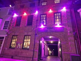 A building with a sign reading "The Lever Restaurant" above an entrance.