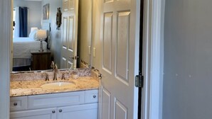 A bathroom with a vanity, mirror, and lights. - 🏖️ Maravilla ~ private beach ~ includes beach setup of 4 chairs, 2 umbrellas 🏖️ (Miramar Beach)