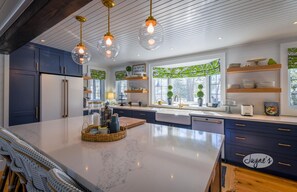 Enjoy cooking in this well-equipped kitchen with a large island, oven, and stainless steel appliances.