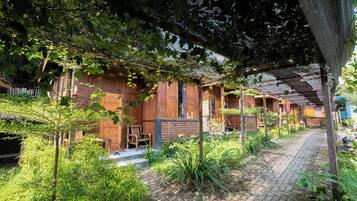 A rustic wooden building with a brick pathway leading to the entrance.