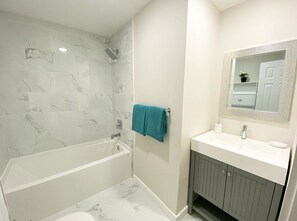 Combined shower/bathtub, towels, soap, toilet paper