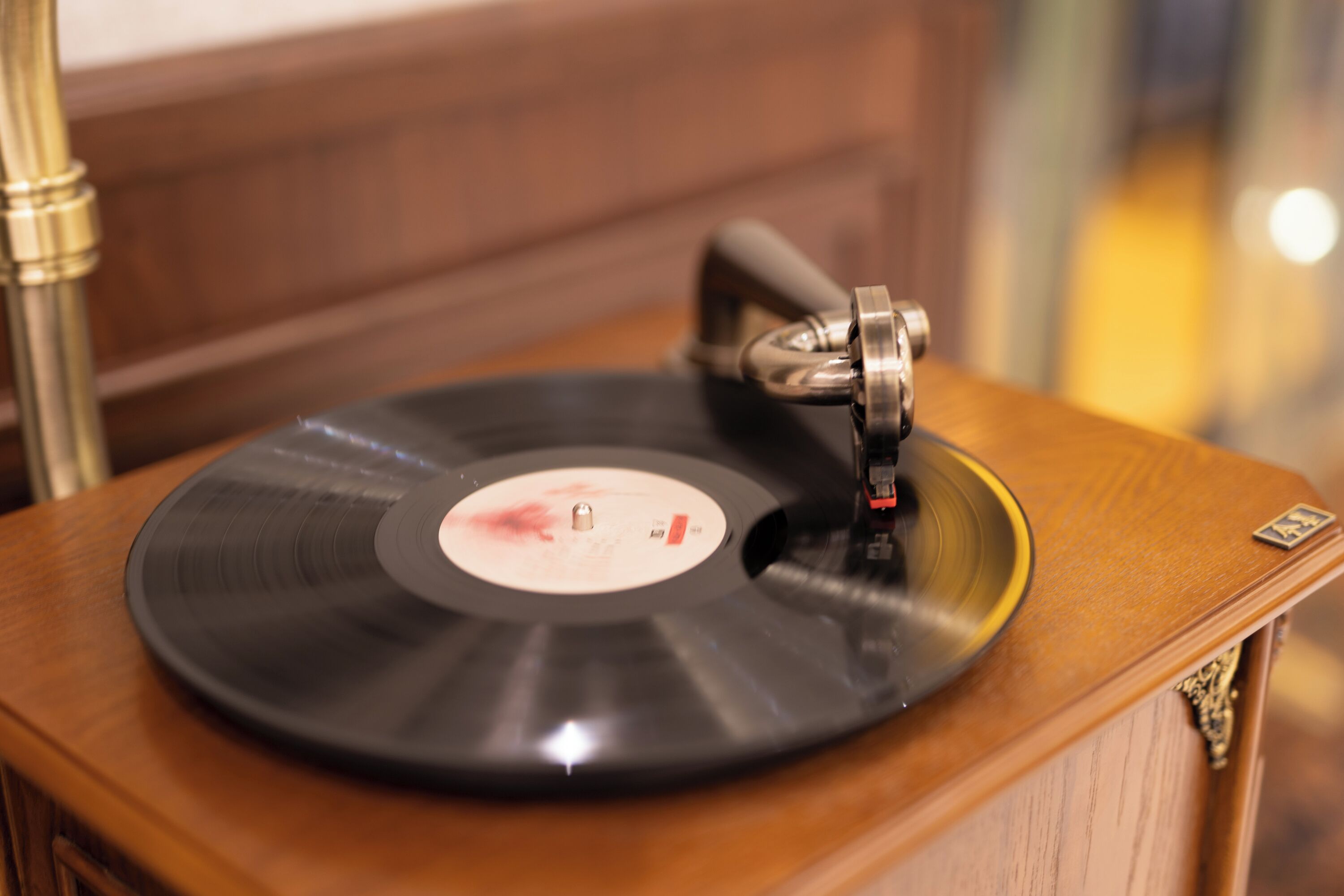 A vinyl record on a wooden turntable.