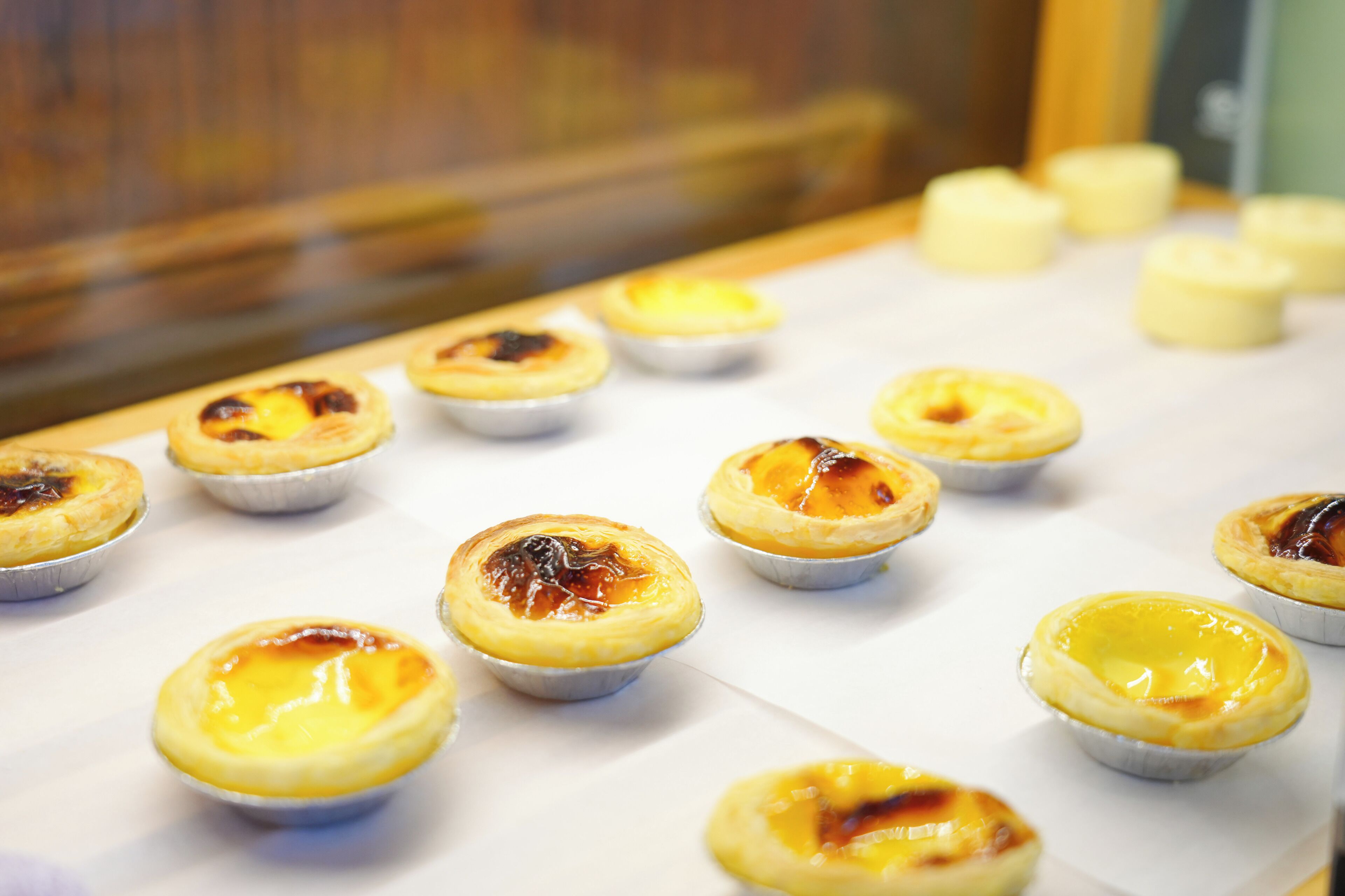 A table with several small, round pastries in individual paper cups.