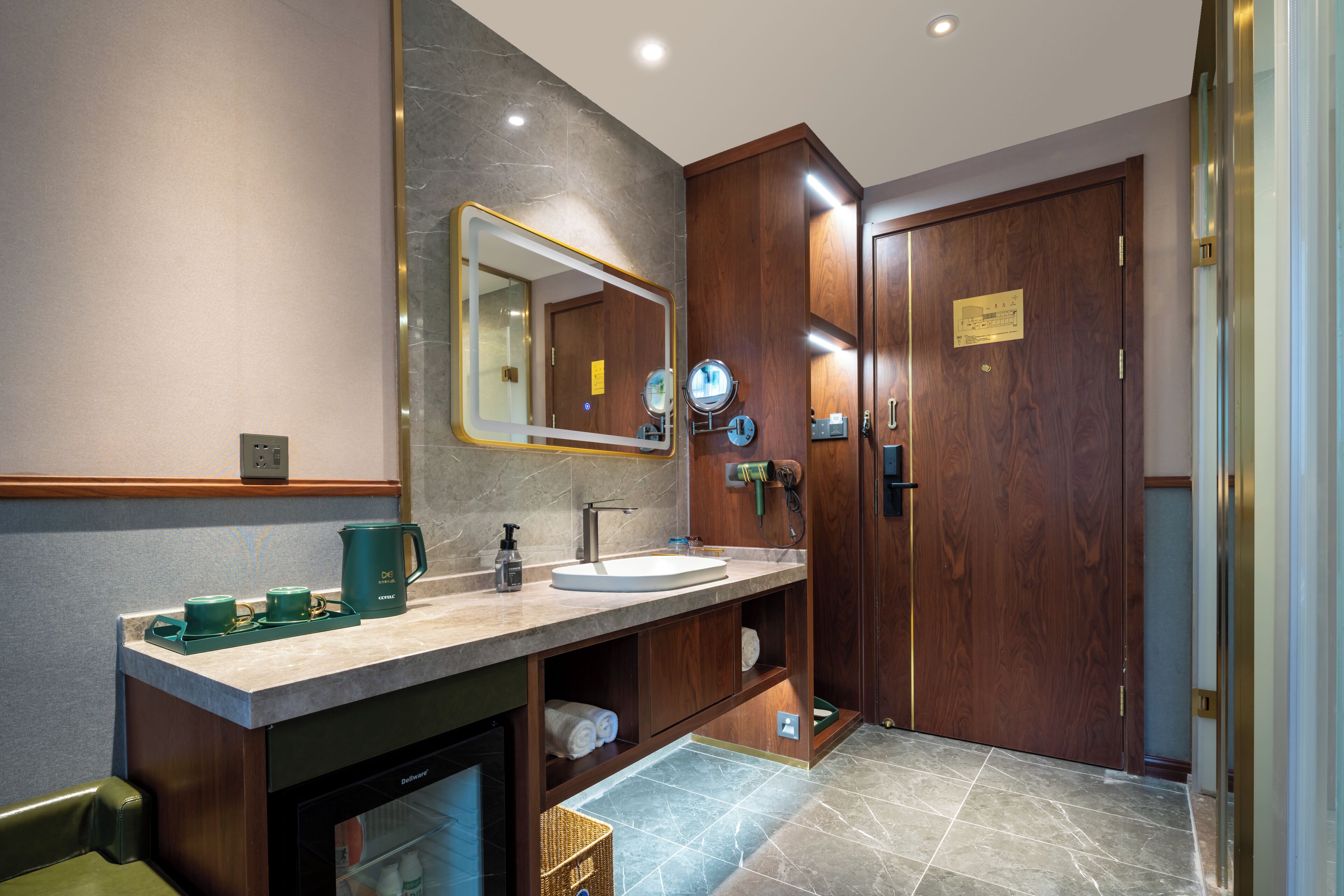 A modern bathroom with a marble sink, wooden cabinets, a large mirror, and a shower area.