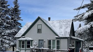 A two-story house with a snow-covered roof and a small porch. - House in Bessemer - 3 BR/1.5 Bathrooms (Bessemer)
