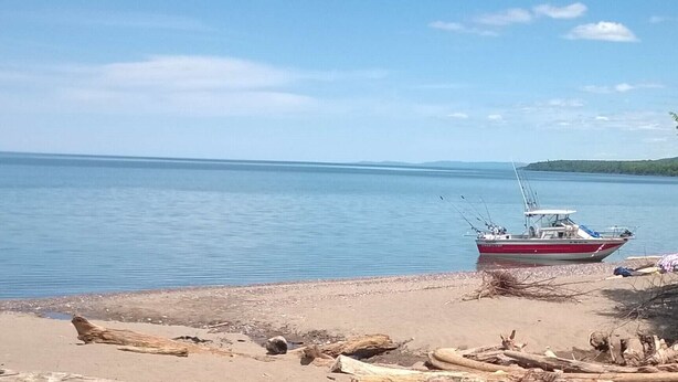 A boat on a calm lake with a sandy shore in the foreground. - House in Bessemer - 3 BR/1.5 Bathrooms (Bessemer)