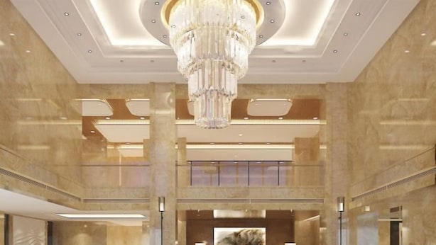 A spacious lobby with a grand chandelier, marble walls, and a reception desk. - Zhongji Garland Hotel (Tianjin)
