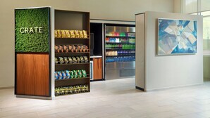 A snack kiosk with a green wall labeled "CRATE" and a refrigerated beverage display. - Courtyard® by Marriott® Atlanta Dunwoody (Atlanta)