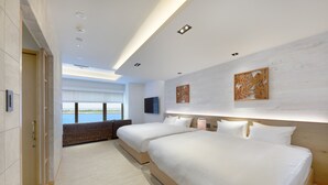 A modern hotel room with two beds, a large window with a view, and a flat-screen TV. - THIRD Ishigaki (Ishigaki)