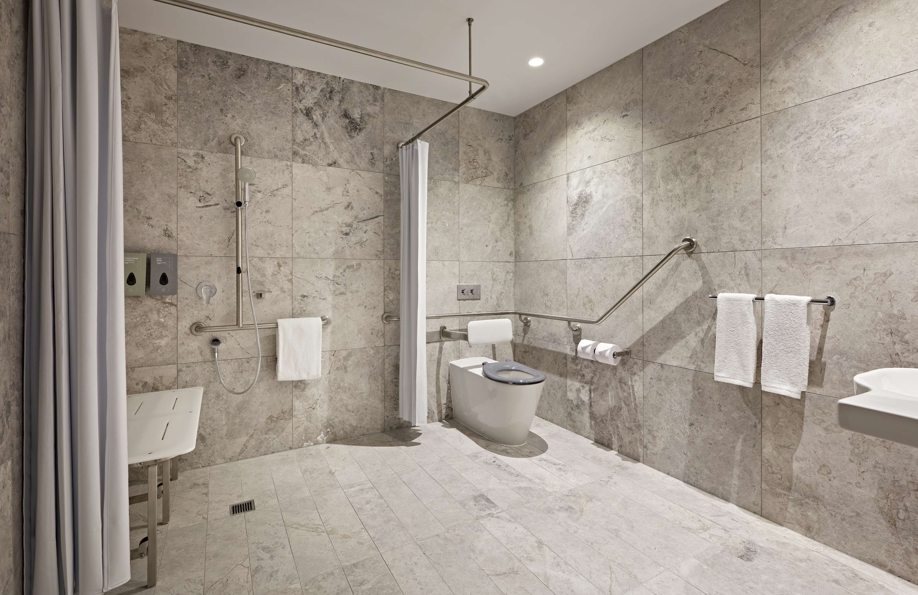accessible king room | bathroom | shower, eco-friendly toiletries, hair dryer, bathrobes