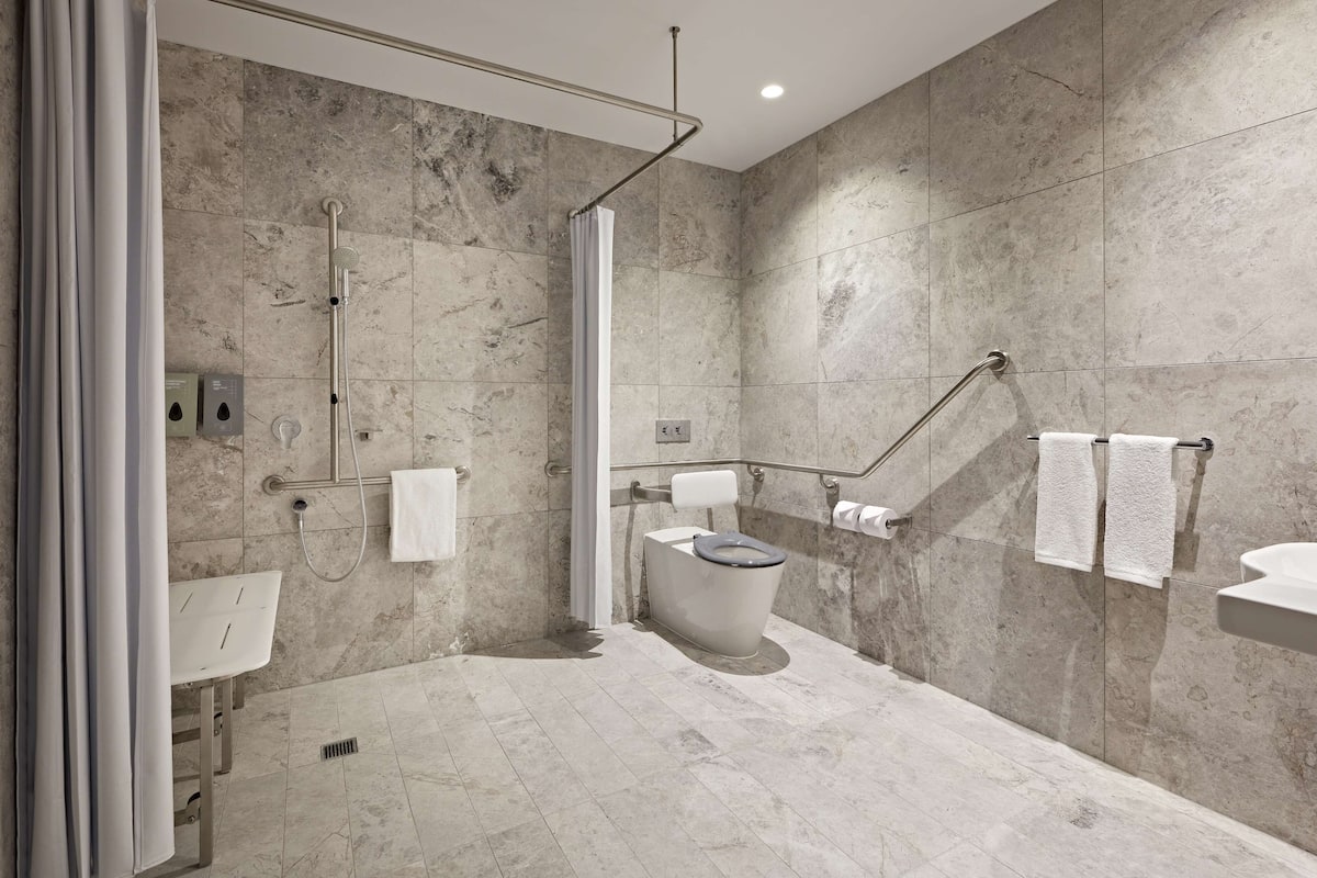 accessible king room | bathroom | shower, eco-friendly toiletries, hair dryer, bathrobes