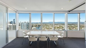 Conference room with expansive city views and a large, rectangular table.