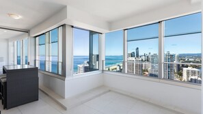 Enjoy expansive ocean views from the large windows in this stylish room with a comfortable sofa and bright, airy atmosphere.