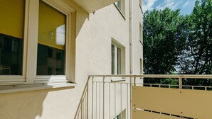 A modern building with a clean facade, a visible staircase, and a balcony with a railing. - ShortStayPoland Św. Wincentego B7 (Warsaw)